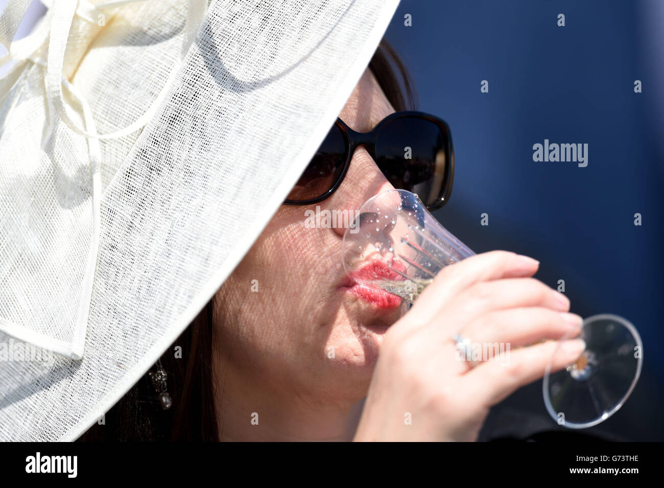 Racegoers enjoy a drink during Investec Ladies Day at Epsom Downs Racecourse, Surrey. Stock Photo