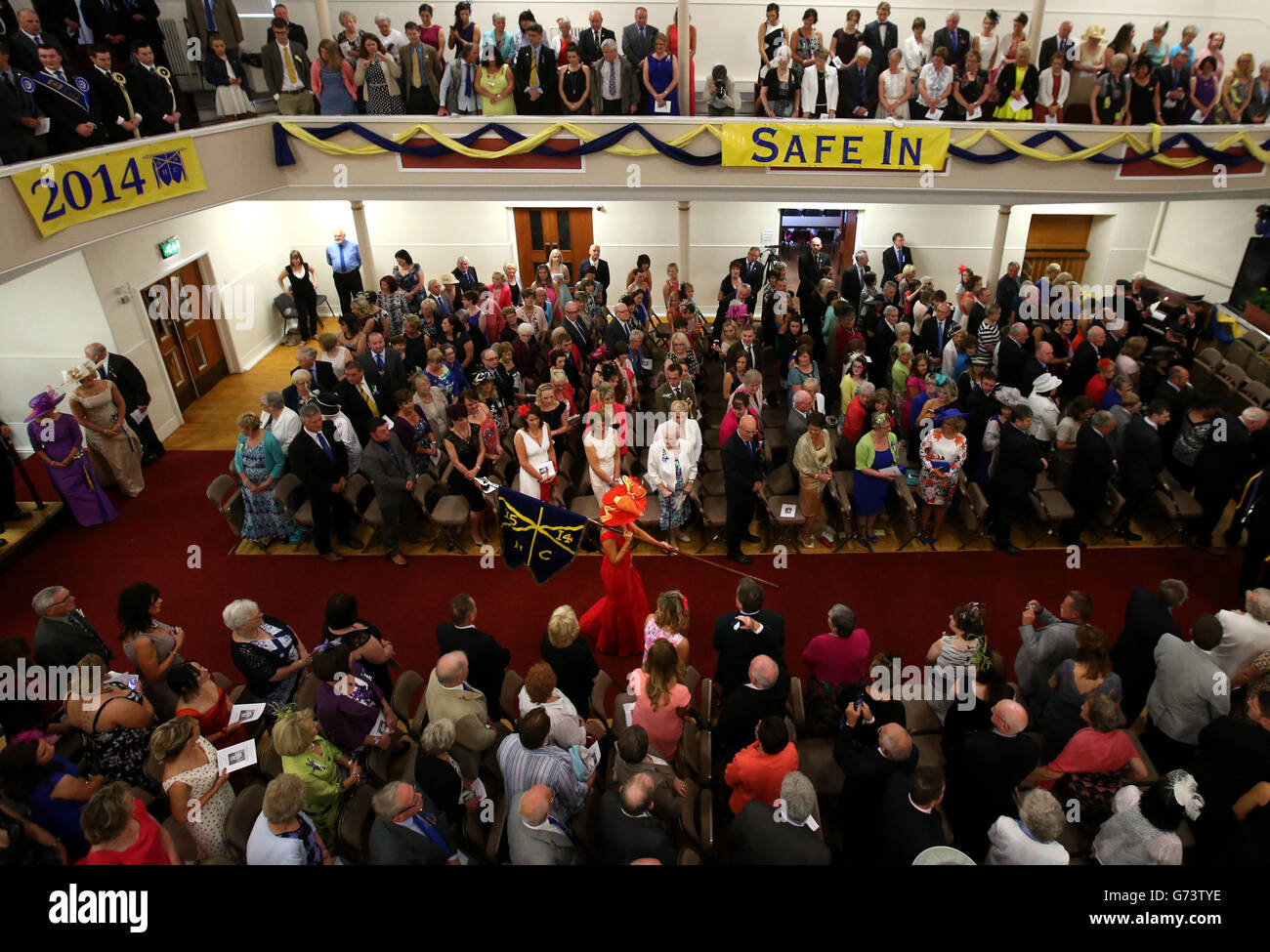 Lass Michelle Paxton carries the flag as she enters the town
