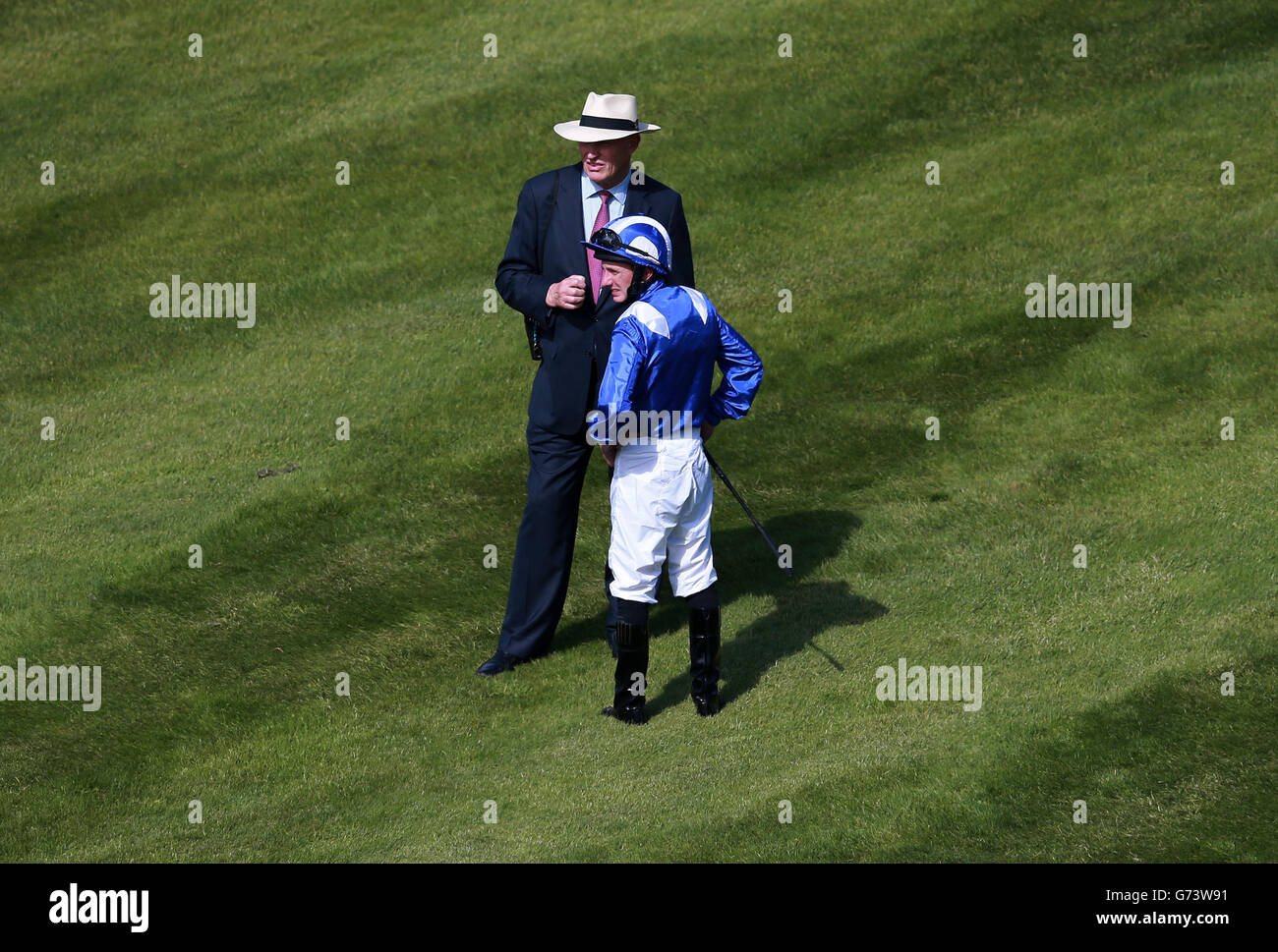 Jockey Paul Hanagan with trainer John Gosden before the Investec Oaks during Investec Ladies Day at Epsom Downs Racecourse, Surrey. Stock Photo