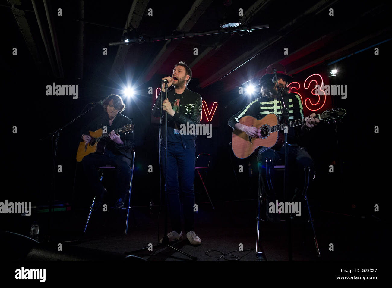 Tom Meighan (centre) of Kasabian performing at HMV in London to celebrate the release of their fifth album '48:13'. Stock Photo