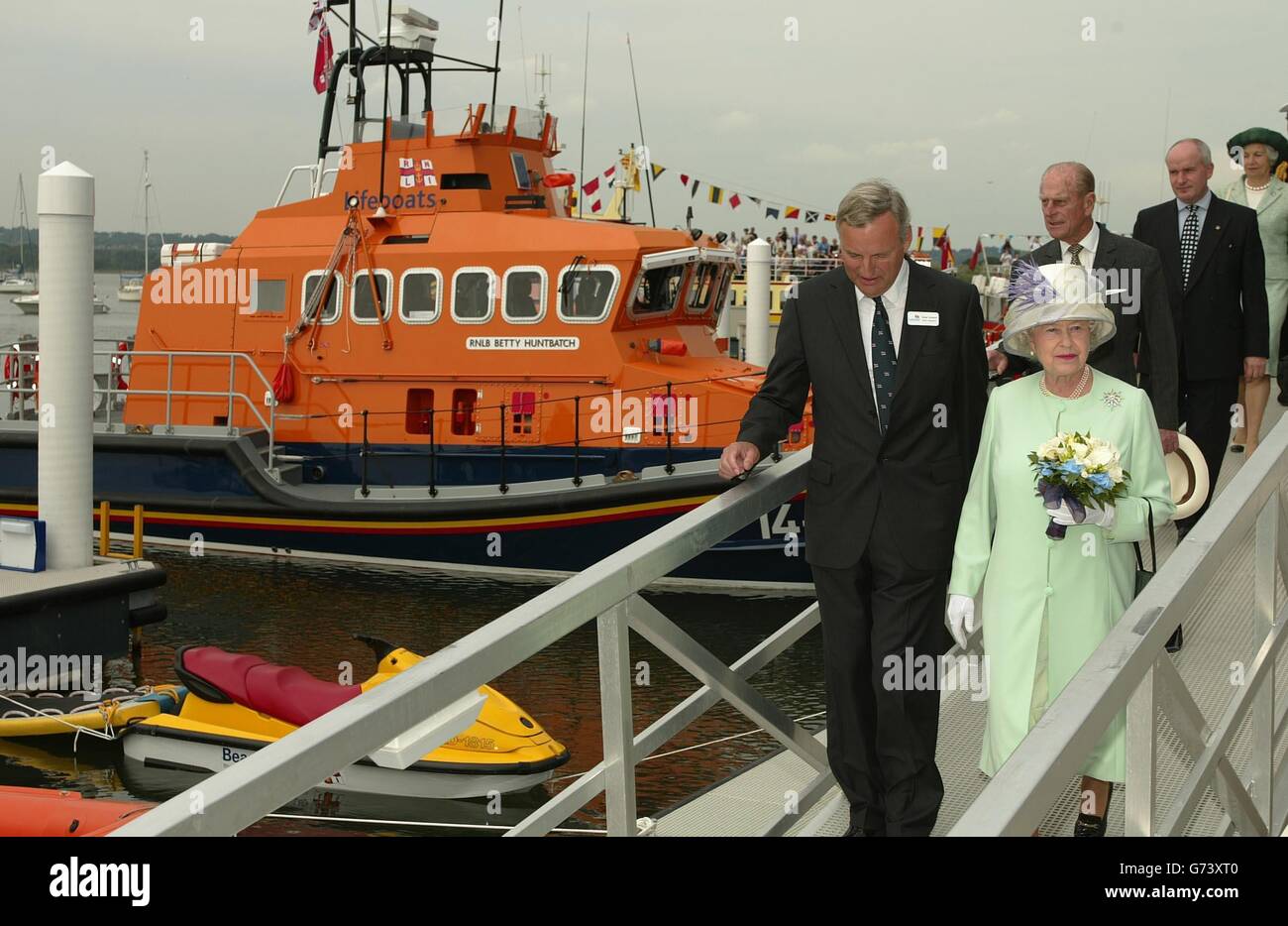 Britain's Queen Elizabeth II and the Duke of Edinburgh during the opening of the organisation's new lifeboat crew training centre in Poole, Dorset. While at the RNLI Lifeboat College, the Queen was given a demonstration of a lifeboat self-righting mechanism. The display, in the college's 25-metre wave tank, involved a four-man crew escaping after a lifeboat capsizes, and then setting off the inflatable device, which turned the boat upright again. Stock Photo
