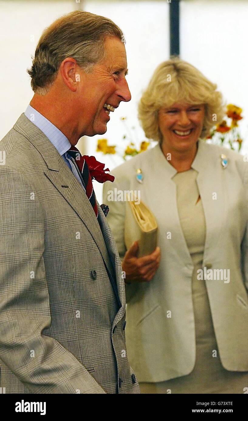 Prince Charles, The Prince of Wales, and Mrs Camilla Parker Bowles walk around the Sandringham Flower Show, Norfolk. The couple, who are on holiday in the area, spent two hours touring the show held on the grounds of the Queen's estate. This is the third year they have attended the event together. 07/08/04: The couple will attend a small highland games, the Mey Games in Caithness, following a tradition laid down by his grandmother, the Queen Mother. Stock Photo