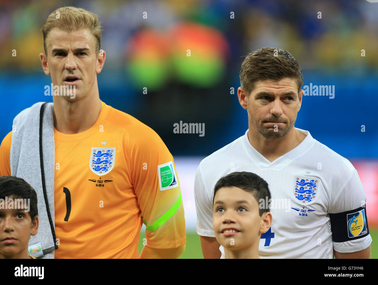 England's Joe Hart and Steven Gerrard (right) during the line up before the FIFA World Cup, Group D match at the Arena da Amazonia, Manaus, Brazil. Stock Photo