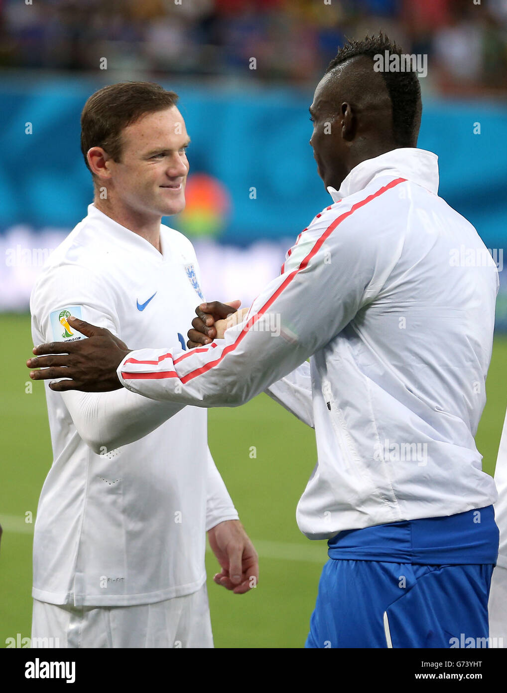Italy's Mario Balotelli shakes hands with England's Wayne Rooney before the FIFA World Cup, Group D match at the Arena da Amazonia, Manaus, Brazil. Stock Photo