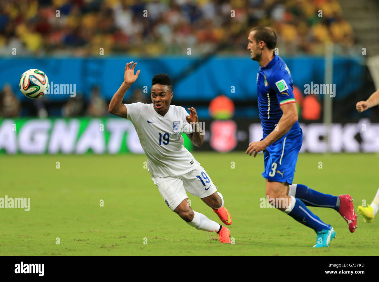 England's Raheem Sterling (left) and Italy's Giorgio Chiellini (right) battle for the ball during the FIFA World Cup, Group D match at the Arena da Amazonia, Manaus, Brazil. Stock Photo