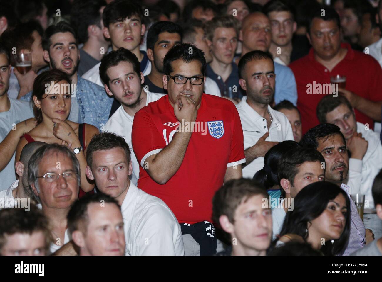 Supporters in the Walkabout Temple, Temple Place in central London watch the England v Italy Group Stage game in the 2014 Fifa World Cup in Brazil. Stock Photo