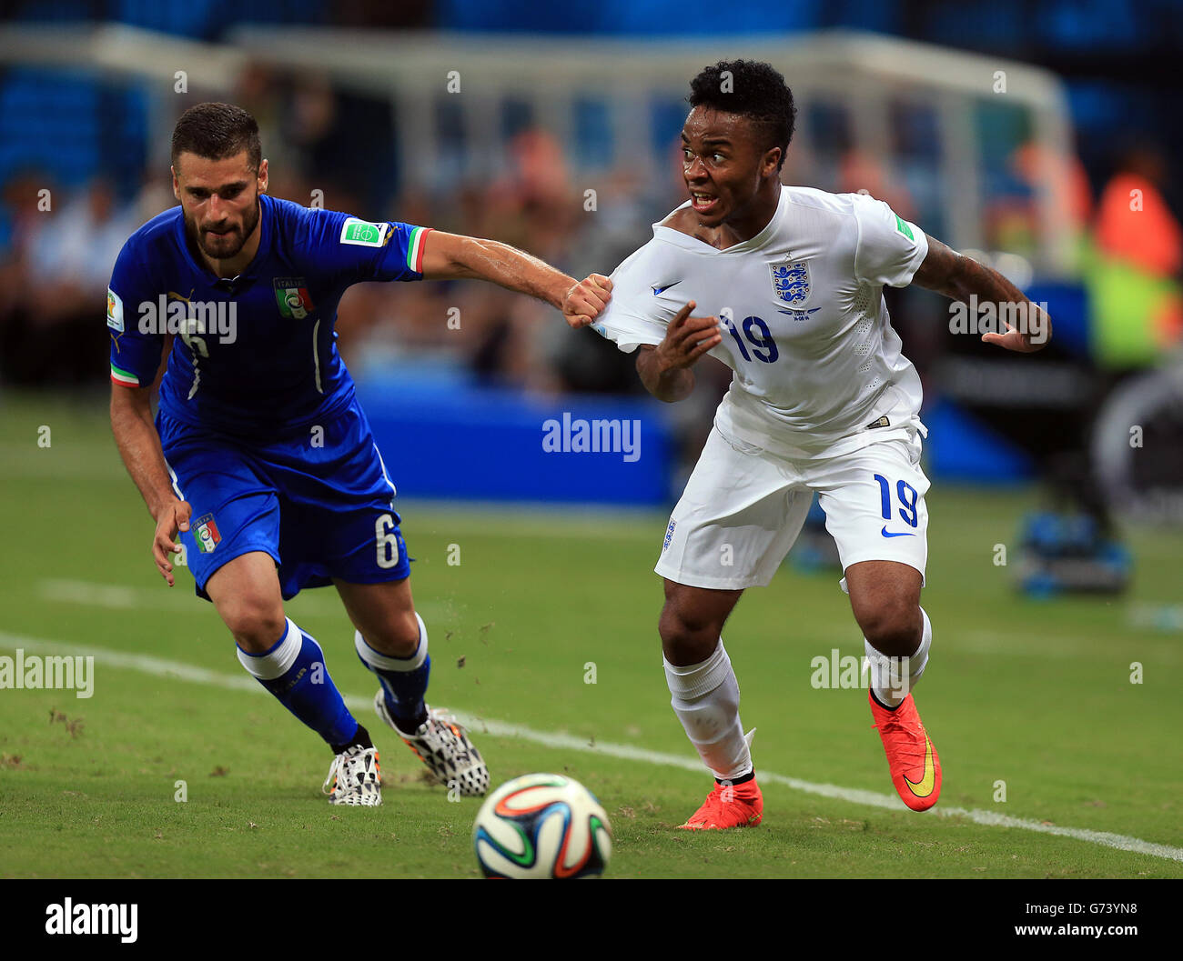 England's Raheem Sterling is held by Italy's Antonio Candreva during the FIFA World Cup, Group D match at the Arena da Amazonia, Manaus, Brazil. Stock Photo