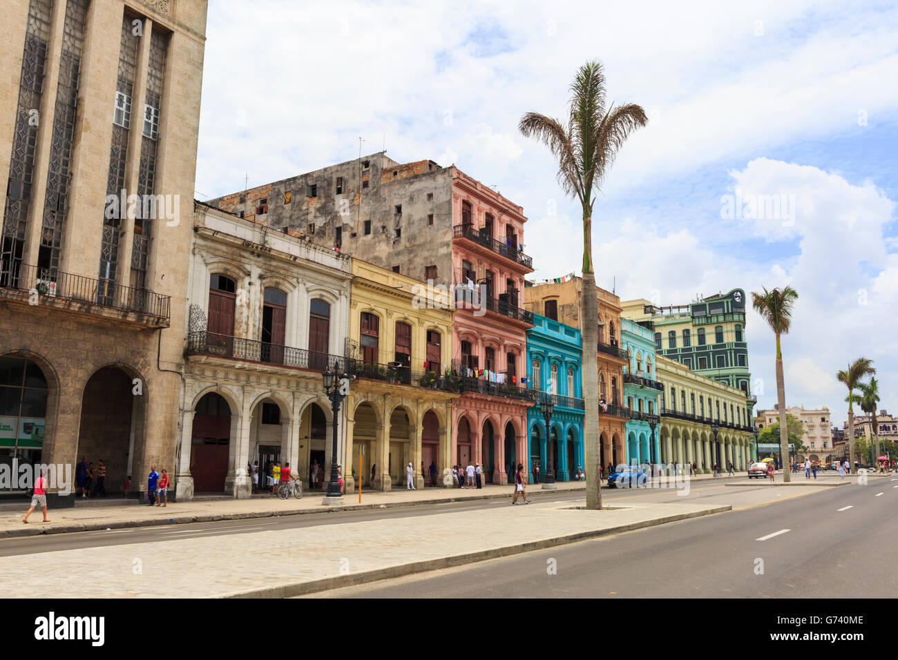 Havana street scene - people walk past colorful houses in Paseo de Marti, Old Havana, Cuba Stock Photo