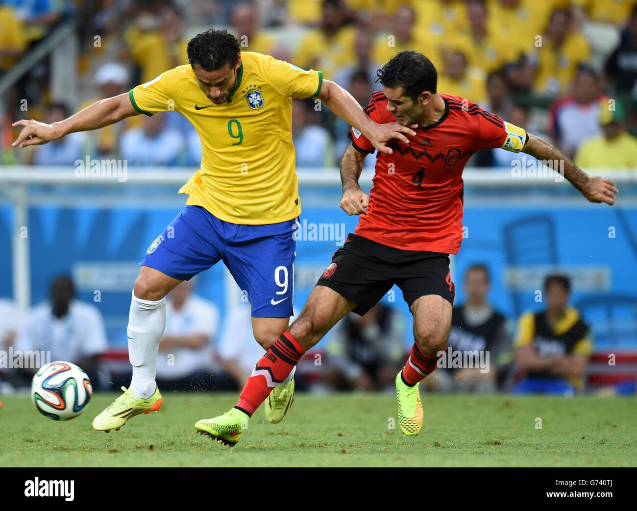 Soccer - FIFA World Cup 2014 - Group A - Brazil v Mexico - Estadio Castelao. Brazil's Fred (left) battles for the ball with Mexico's Rafael Marquez Stock Photo