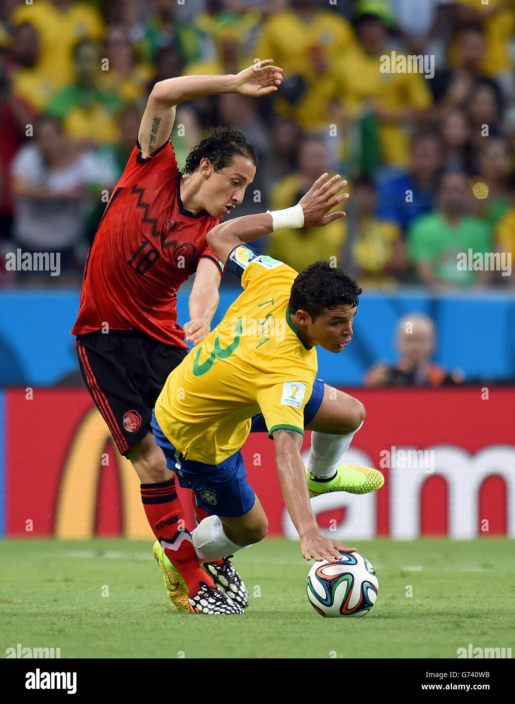 Mexico's Andres Guardado (left) and Brazil's Thiago Silva battle for the ball Stock Photo