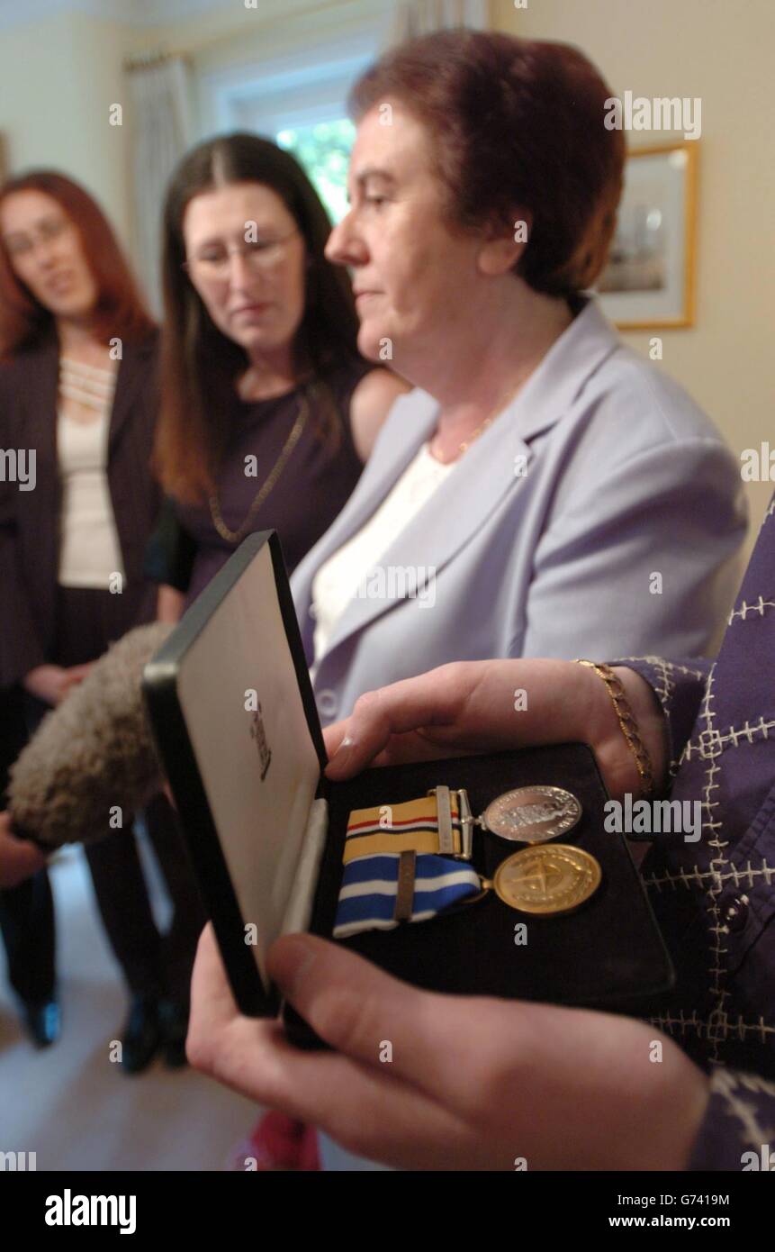 Mary Malone (centre-right) is pictured besides an Iraq 2004 medal and a NATO Kosovo 2000 medal, awarded post-humously for her son Lance Corporal Ian Malone, at the British Military Attache's residence, in south Dublin,. Lance Corporal Malone was killed while serving as an Irish Guard in the British Army in Iraq in April 2003. Stock Photo