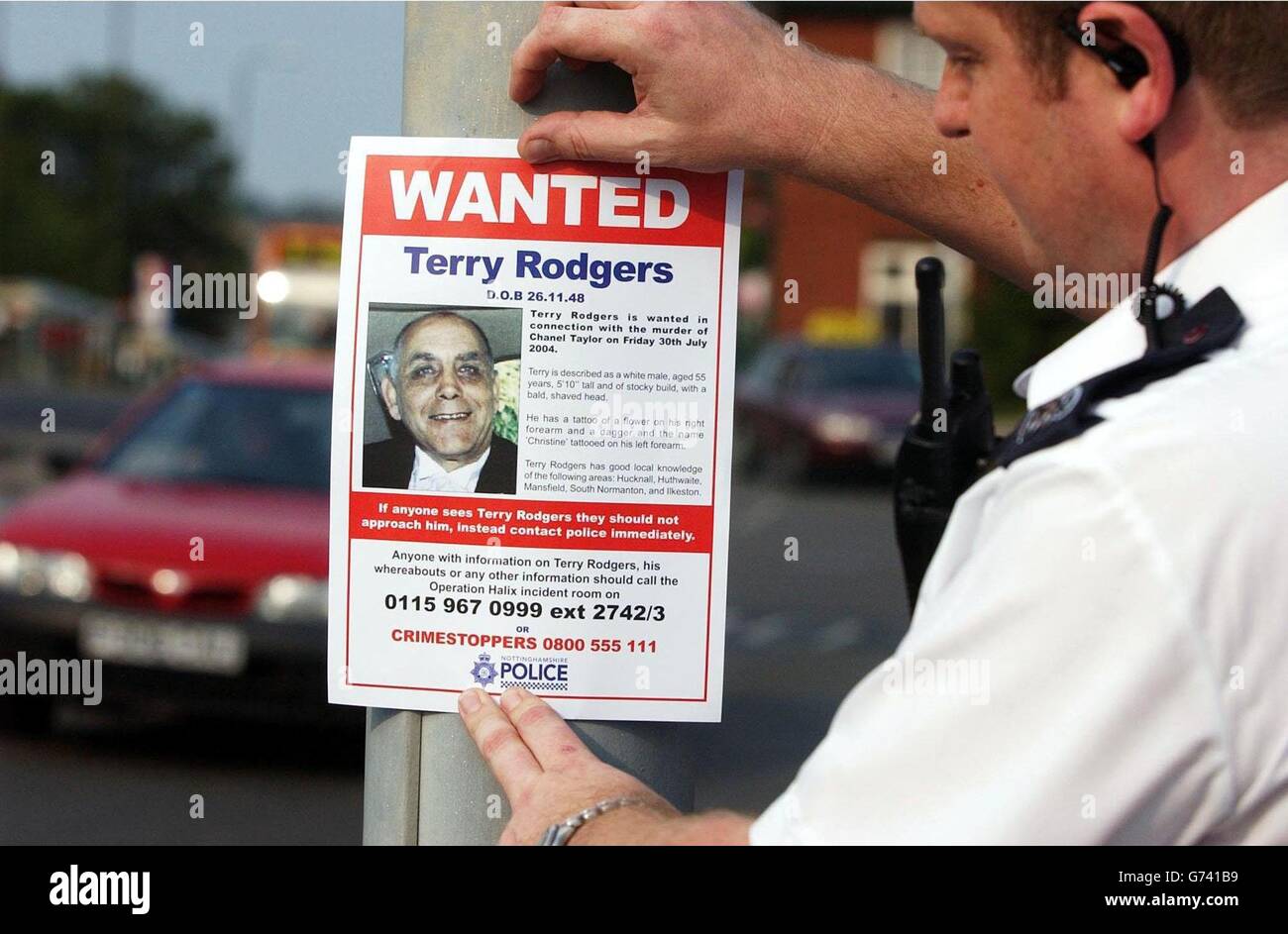 Nottinghamshire Police hand out 'Wanted' leaflets for murder suspect Terry Rodgers at Sutton-in-Ashfield and Hucknall in Nottinghamshire. Terry Rodgers went missing almost a week ago after his daughter, Chanel Taylor, was shot in the head in her home in Huthwaite, Nottinghamshire. Police have still not found the murder weapon and warned people not to approach the tattooed 55-year-old, who they believe could be in hiding following the shooting. Stock Photo