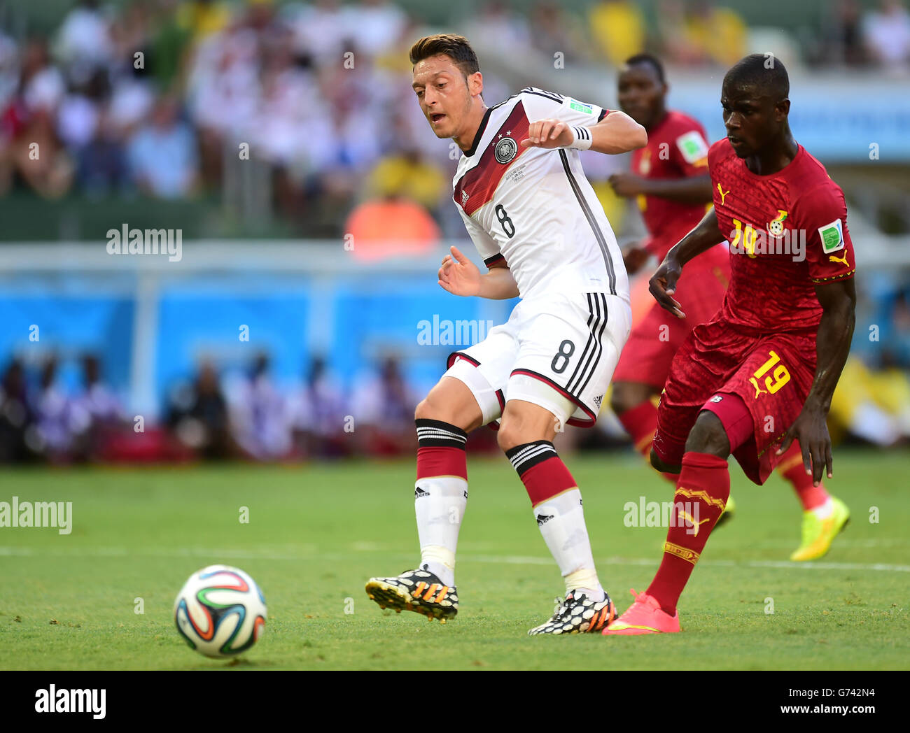 Germany's Mesut Ozil (left) wins the ball ahead of Ghana's Jonathan Mensah Stock Photo