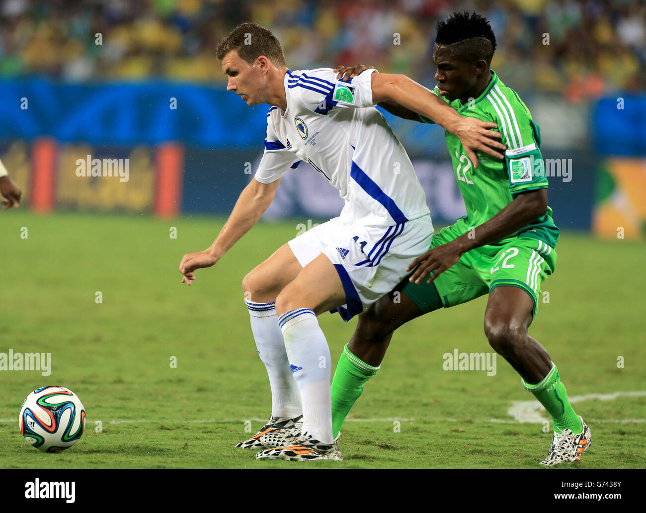 Nigeria's Kenneth Omeruo (right) and Bosnia & Herzegovina's Edin Dzeko battle for the ball Stock Photo
