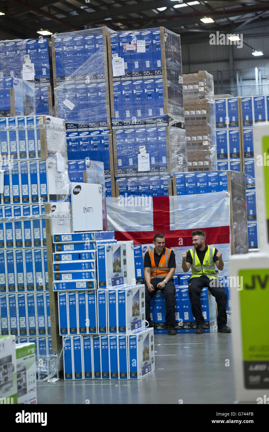 Pawel Majdek (left) and Stuart Berry, packers at Currys and PC World's distribution centre in Newark, work on delivery fulfilment as the demand for televisions, ahead of this year's summer of sport, has increased due to the retailer's Cash for Goals promotion. Stock Photo