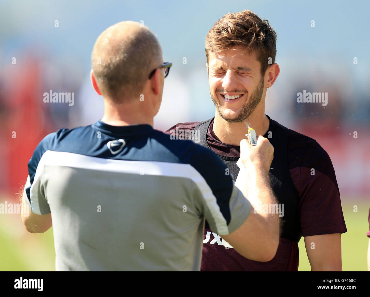 Soccer - FIFA World Cup 2014 - Group D - England v Italy - England Training Session and Press Conference - Urca Military Trai.... England's Adam Lallana is sprayed with water during the training session at Urca Military Training Ground, Rio de Janeiro, Brazil. Stock Photo