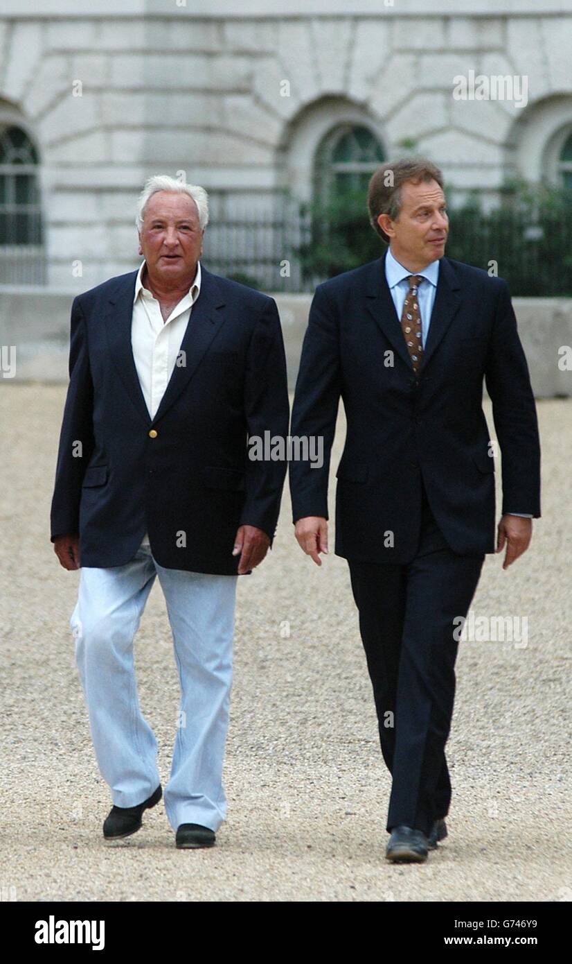 British Prime Minister Tony Blair, right and film director, Michael Winner walk from Downing Street to the Mall in London to perform a symbolic ground breaking ceremony at the site of The National Police Memorial which will be unveiled by the Queen in late October this year. The Memorial is designed as a donation by Lord Norman Foster. Stock Photo