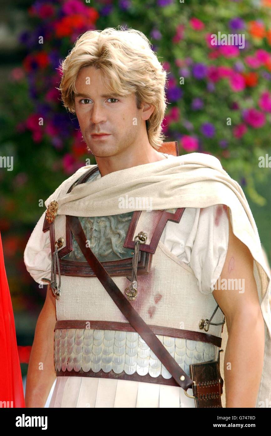 Staff move the new waxwork figure of Colin Farrell, as Alexander the Great during a photocall to launch new attraction 'Warriors' at Madame Tussauds in central London. The new live action experience uses world first digital technology to transform Tussauds into an ancient combat arena. Stock Photo