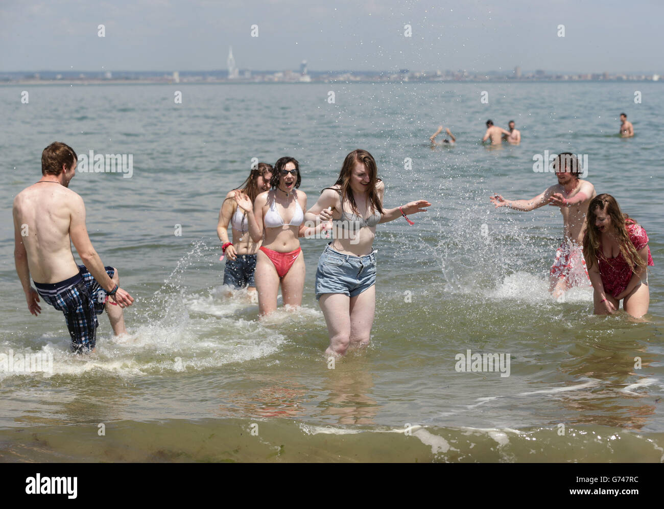 Festival goers taking a dip in the sea at the beach in Ryde, before heading to the Isle of Wight Festival. Stock Photo