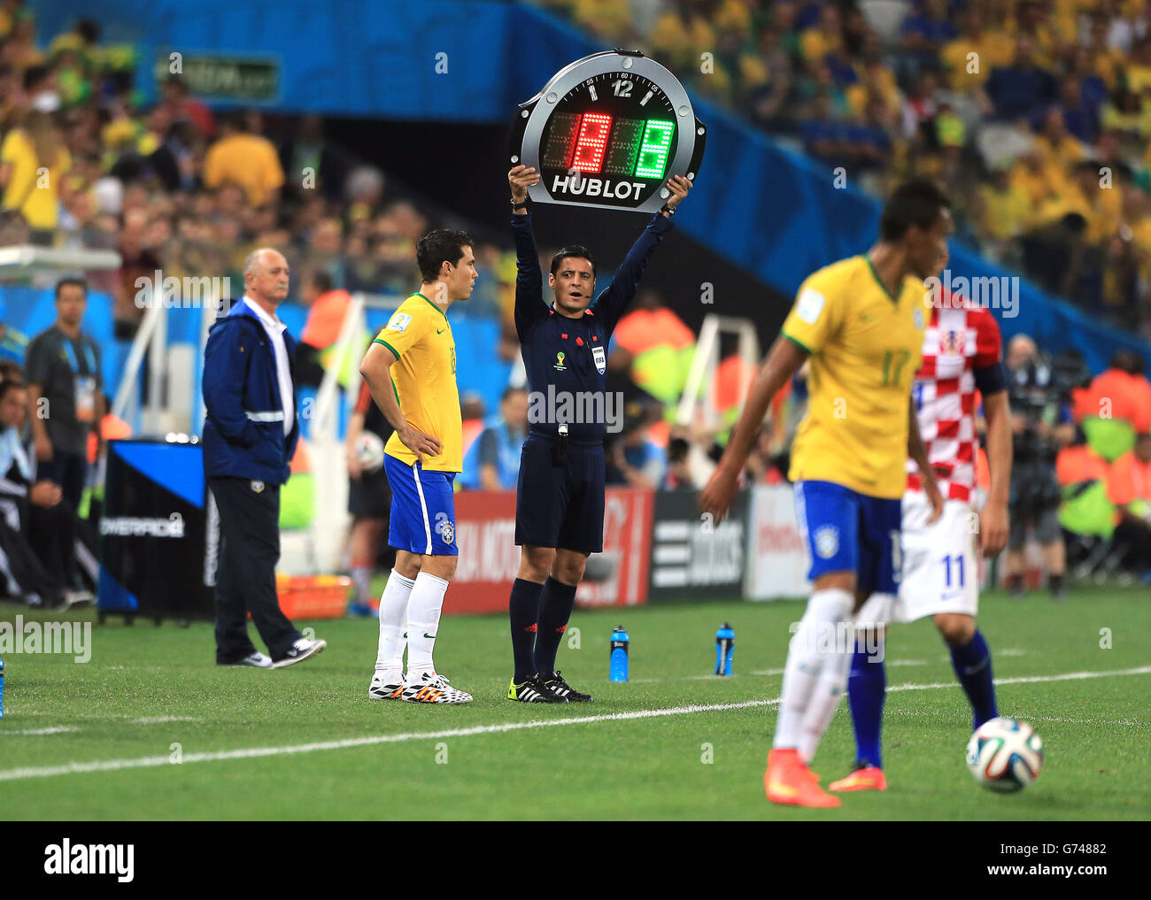 Soccer - FIFA World Cup 2014 - Group A - Brazil v Croatia - Arena Corinthians. Fourth Official Alireza Faghani (centre) holds up the board as Brazil's Hernanes prepares to come on as a substitute Stock Photo