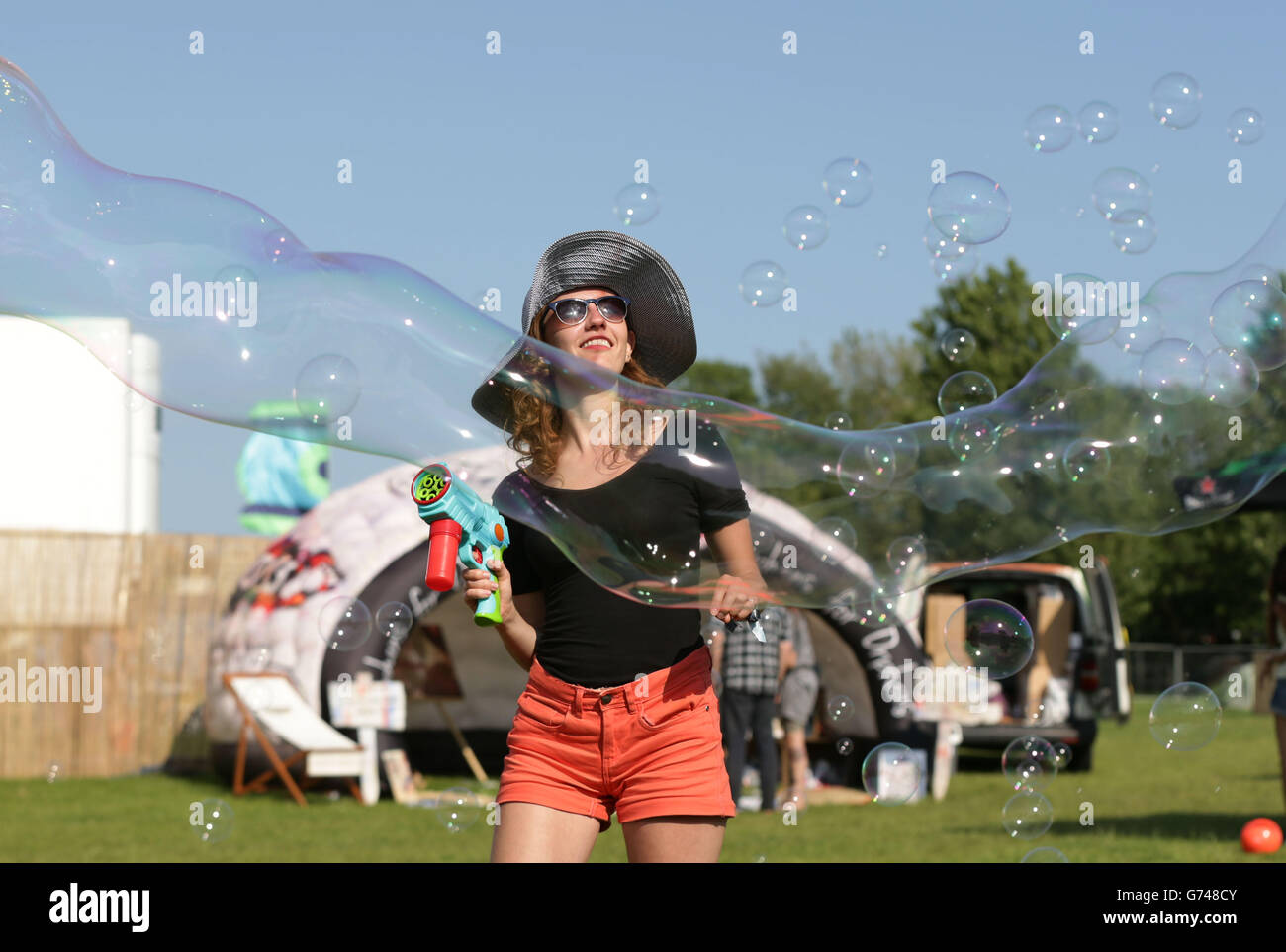 Festival goers reacting to giant bubbles at the Isle of Wight Festival