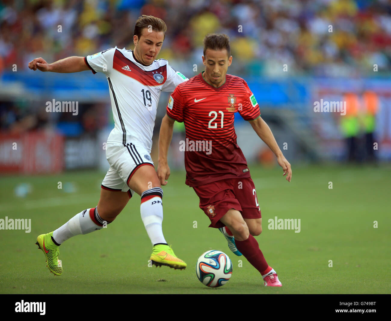 Soccer - FIFA World Cup 2014 - Group G - Germany v Portugal - Arena Fonte Nova. Germany's Mario Gotze (left) and Portugal's Joao Pereira battle for the ball Stock Photo