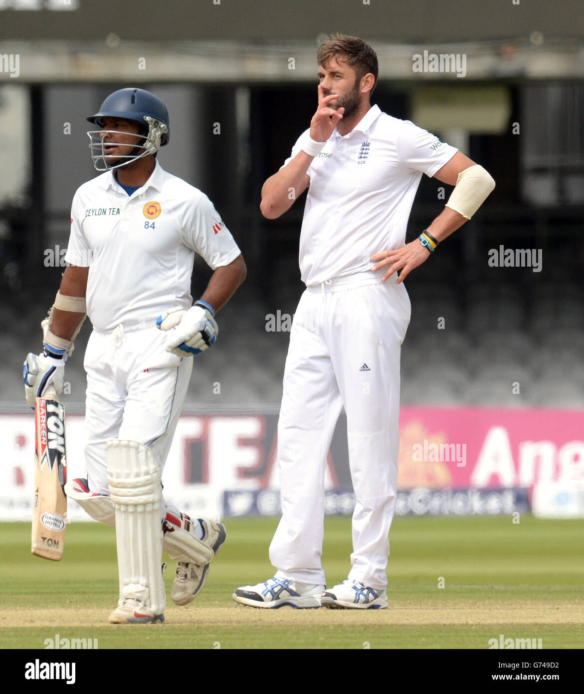 England's Liam Plunkett reacts as Sri Lanka's Kumar Sangakkara runs ...