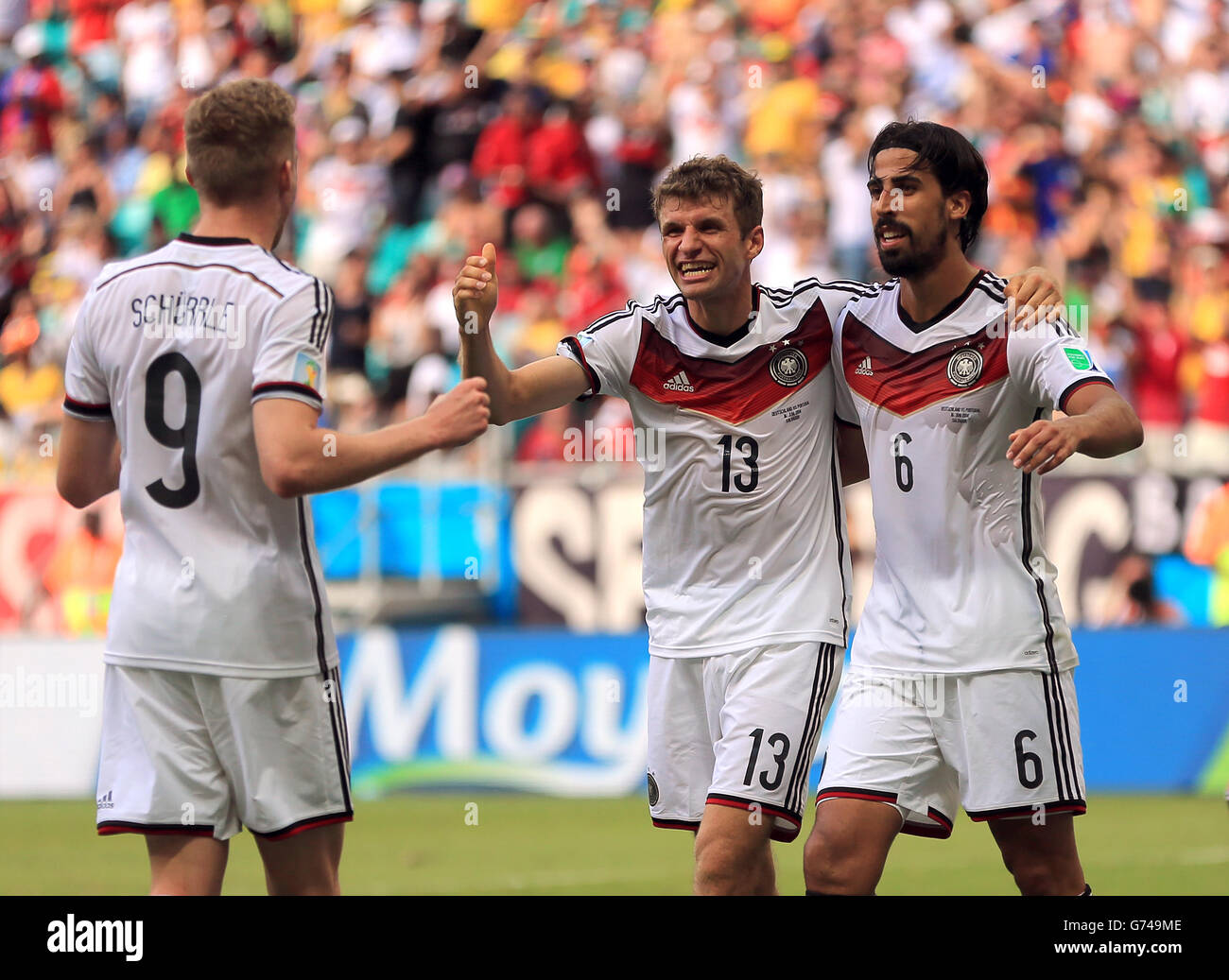 Germany's Thomas Muller celebrates scoring his side's fourth goal of the game to complete his hat-trick with Andre Schurrle and Sami Khedira (right) Stock Photo