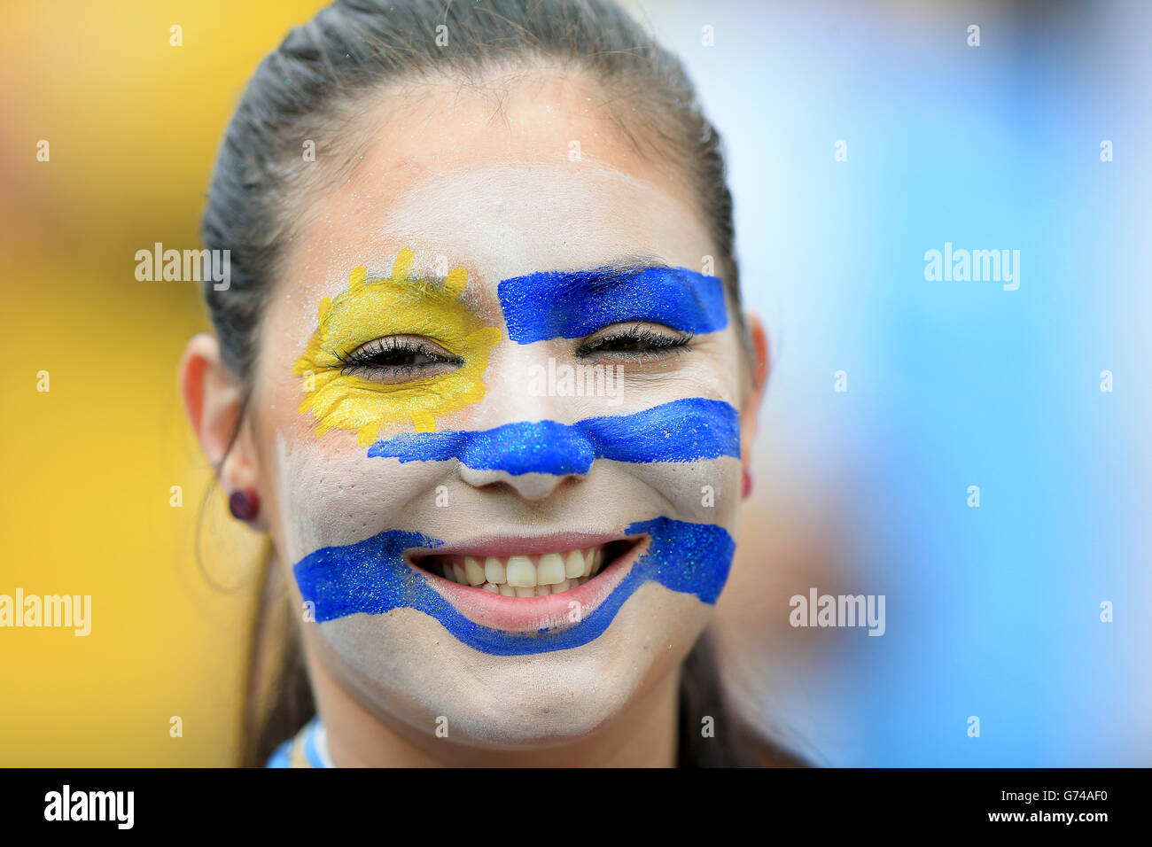 A Uruguay fan wearing face paint before the game during the Group D match the Estadio do Sao Paulo, Sao Paulo, Brazil. Stock Photo
