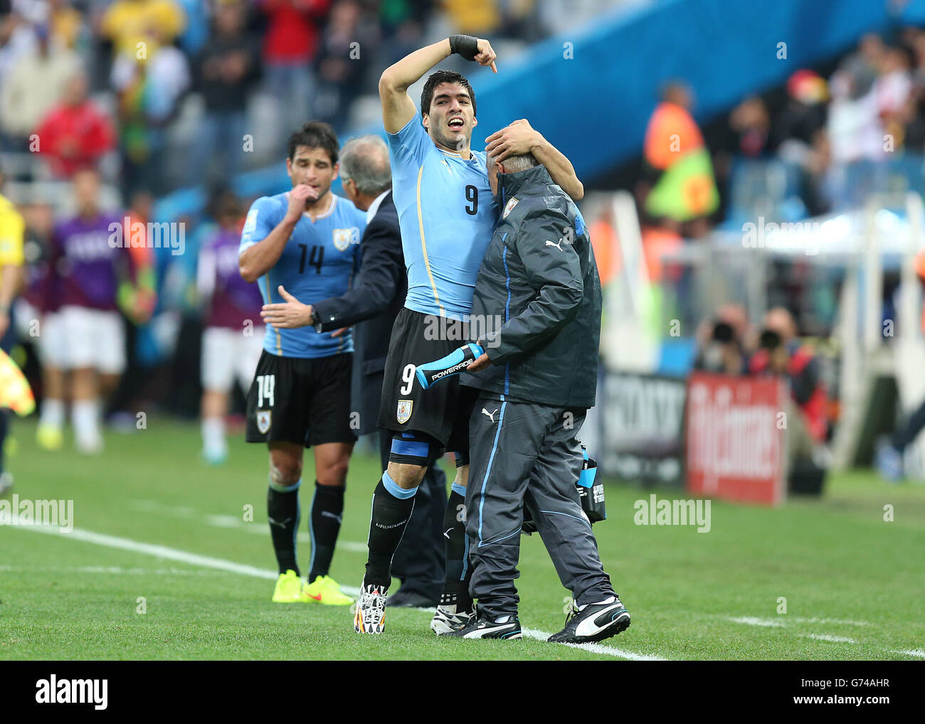 Uruguay's Luis Suarez celebrates on the touchline after scoring his side's first goal during the Group D match the Estadio do Sao Paulo, Sao Paulo, Brazil. Stock Photo