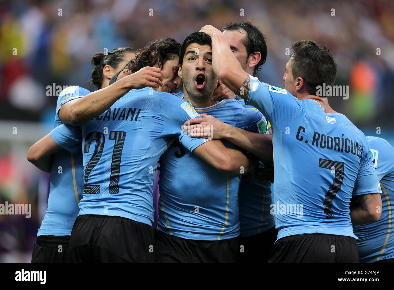 Uruguay's Luis Suarez (centre) celebrates scoring their first goal of the game during the Group D match the Estadio do Sao Paulo, Sao Paulo, Brazil. Stock Photo