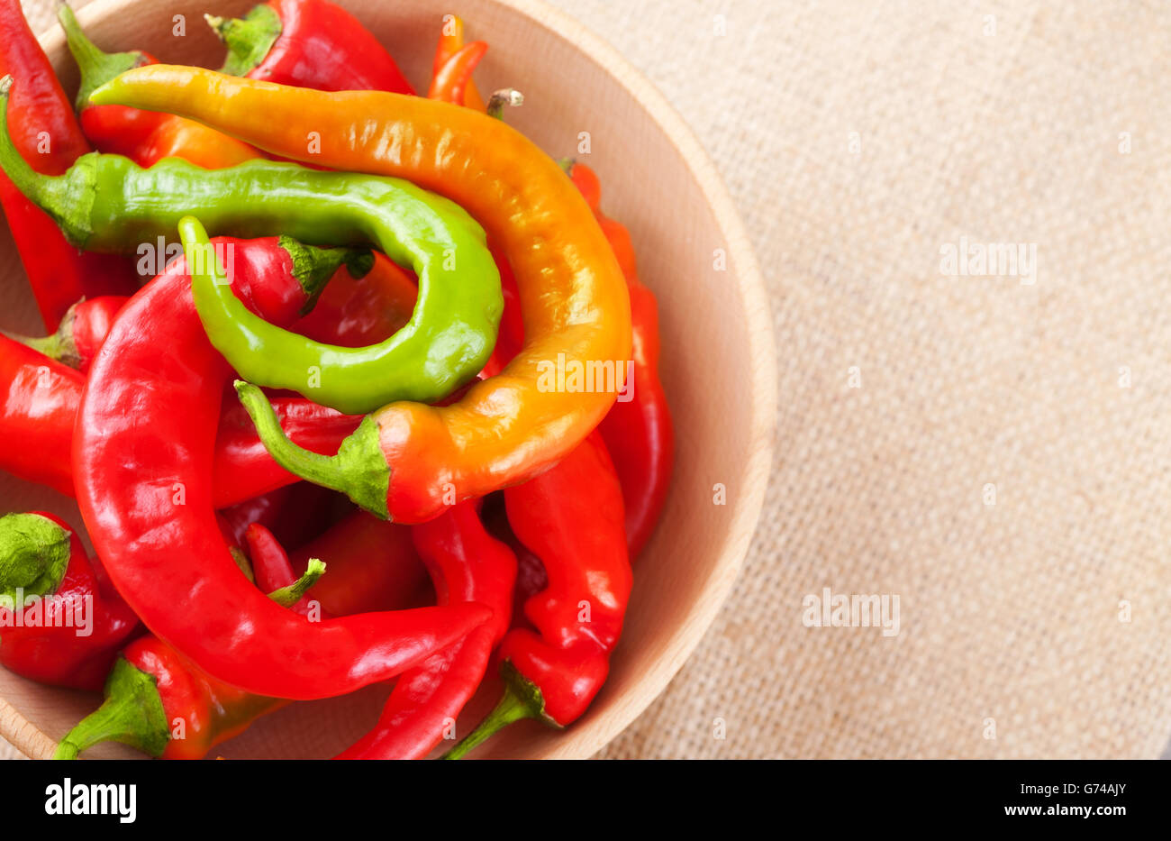 Hot red and green chili peppers in a bowl on a table, top view Stock ...