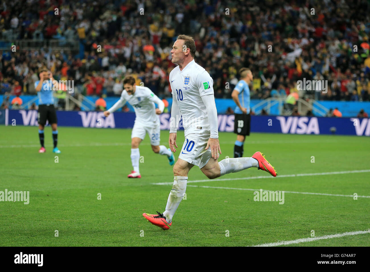 England's Wayne Rooney celebrates scoring their first goal of the game during the Group D match the Estadio do Sao Paulo, Sao Paulo, Brazil. Stock Photo
