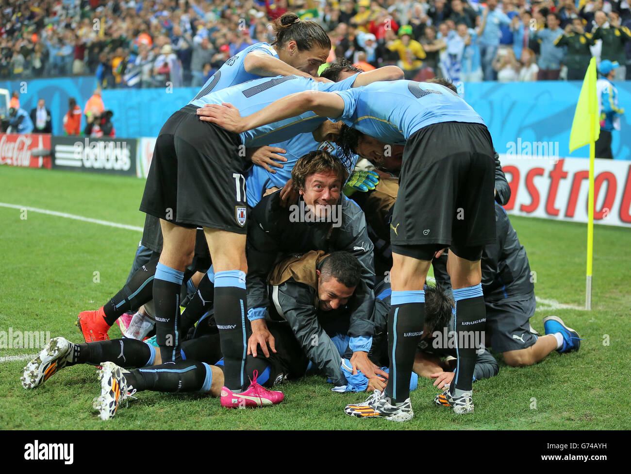 Uruguay's Luis Suarez is mobbed by his team-mates after scoring his side's second goal during the Group D match the Estadio do Sao Paulo, Sao Paulo, Brazil. Stock Photo