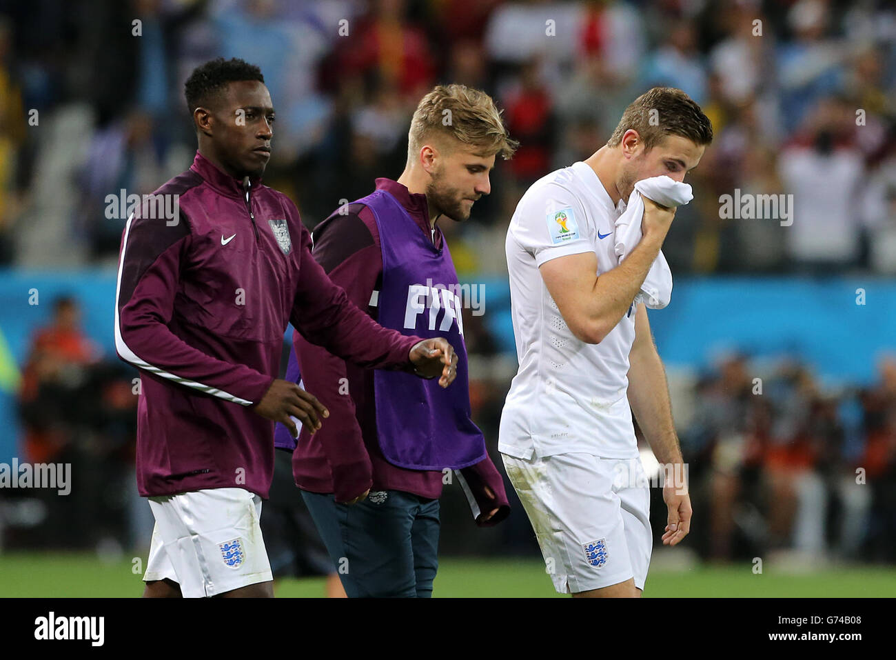 England's Danny Welbeck, Luke Shaw and Jordan Henderson (left to right) are left dejected after the final whistle during the Group D match the Estadio do Sao Paulo, Sao Paulo, Brazil. Stock Photo