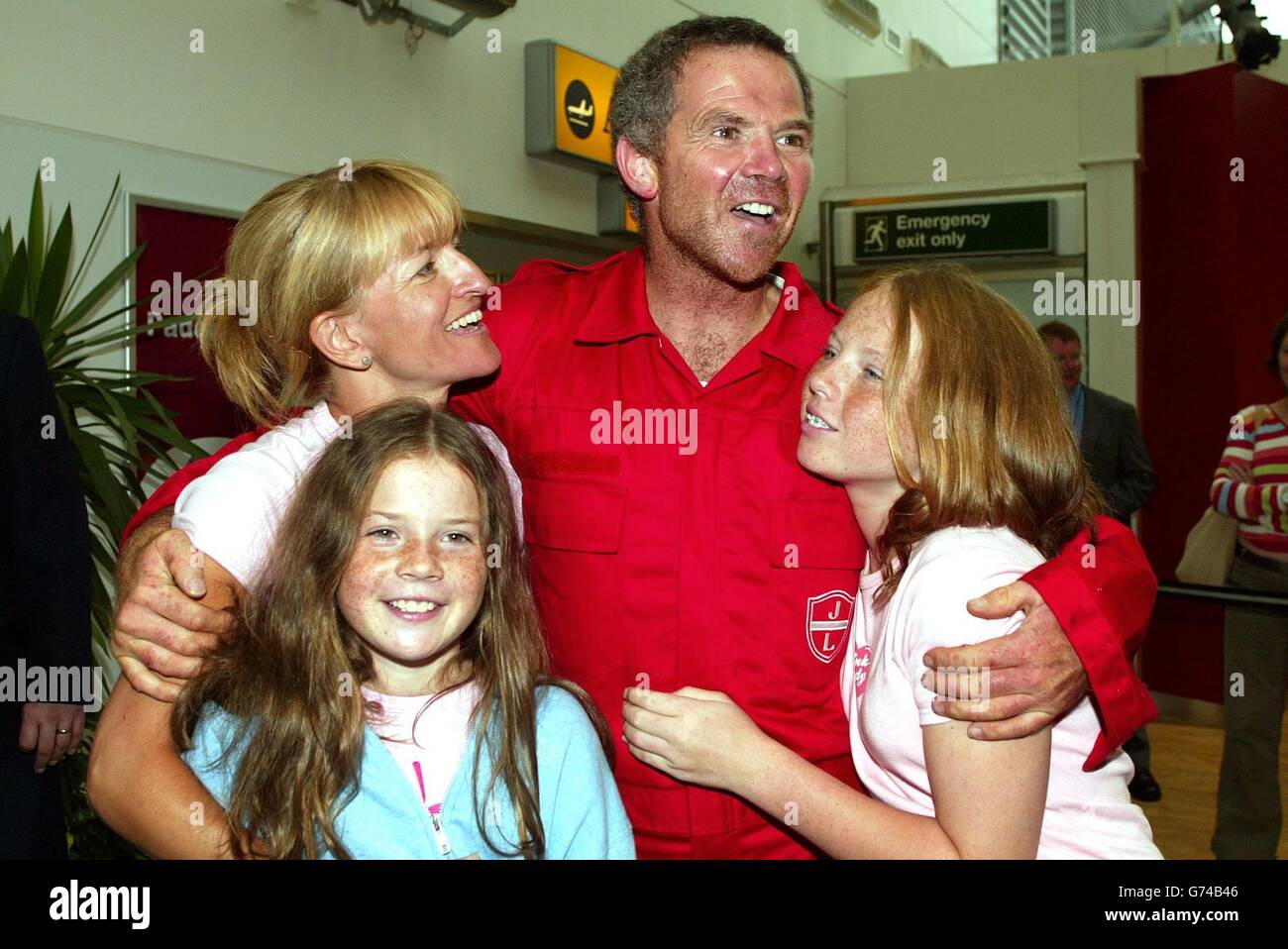 Transatlantic rower Mark Stubbs is reunited with his wife Paula and children Brianna, 13 (right) and Victoria, 10, after returning to Southampton Airport. Mark and three colleagues were attempting to break the 108-year-old record for rowing across the Atlantic Ocean when their boat 'Pink Lady' was smashed apart by a giant wave 300 miles west of the Scilly Isles yesterday. Stock Photo