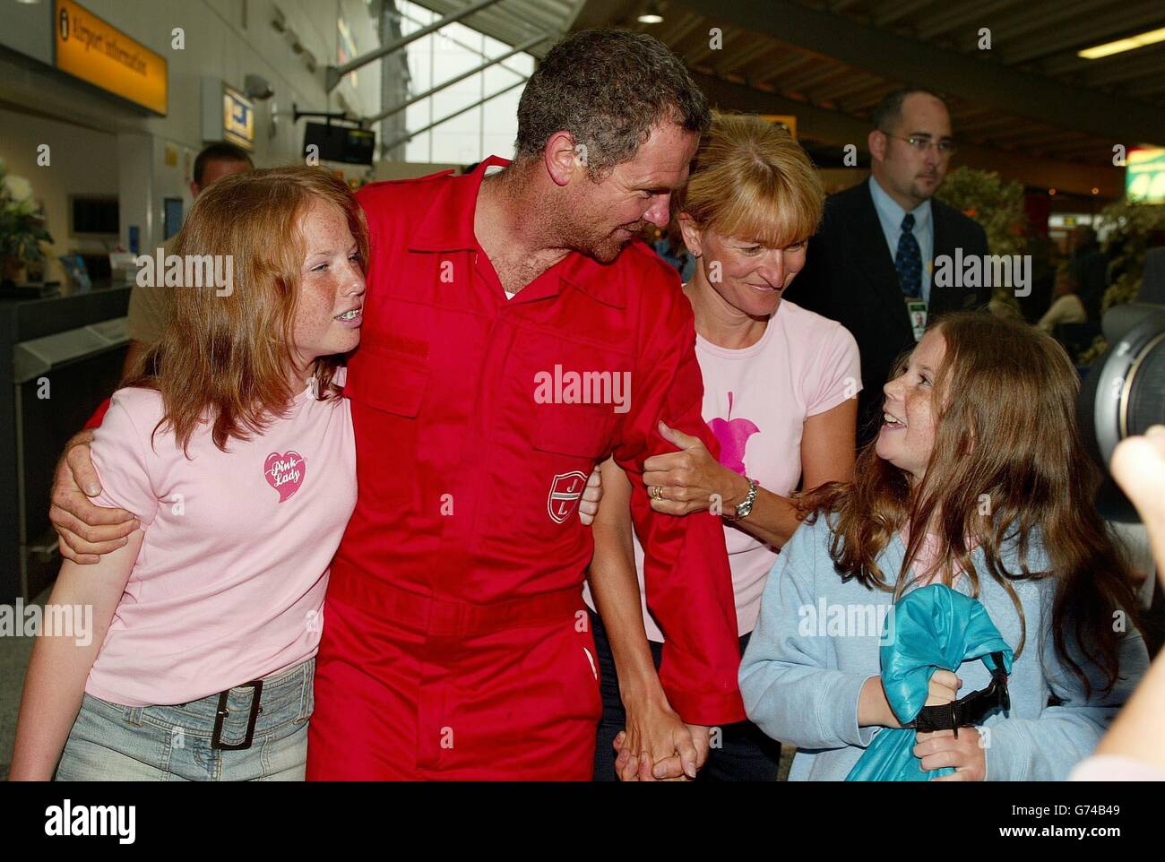 Transatlantic rower Mark Stubbs is reunited with his wife Paula and children Brianna, 13 (left) and Victoria, 10, after returning to Southampton Airport. Mark and three colleagues were attempting to break the 108-year-old record for rowing across the Atlantic Ocean when their boat 'Pink Lady' was smashed apart by a giant wave 300 miles west of the Scilly Isles yesterday. Stock Photo