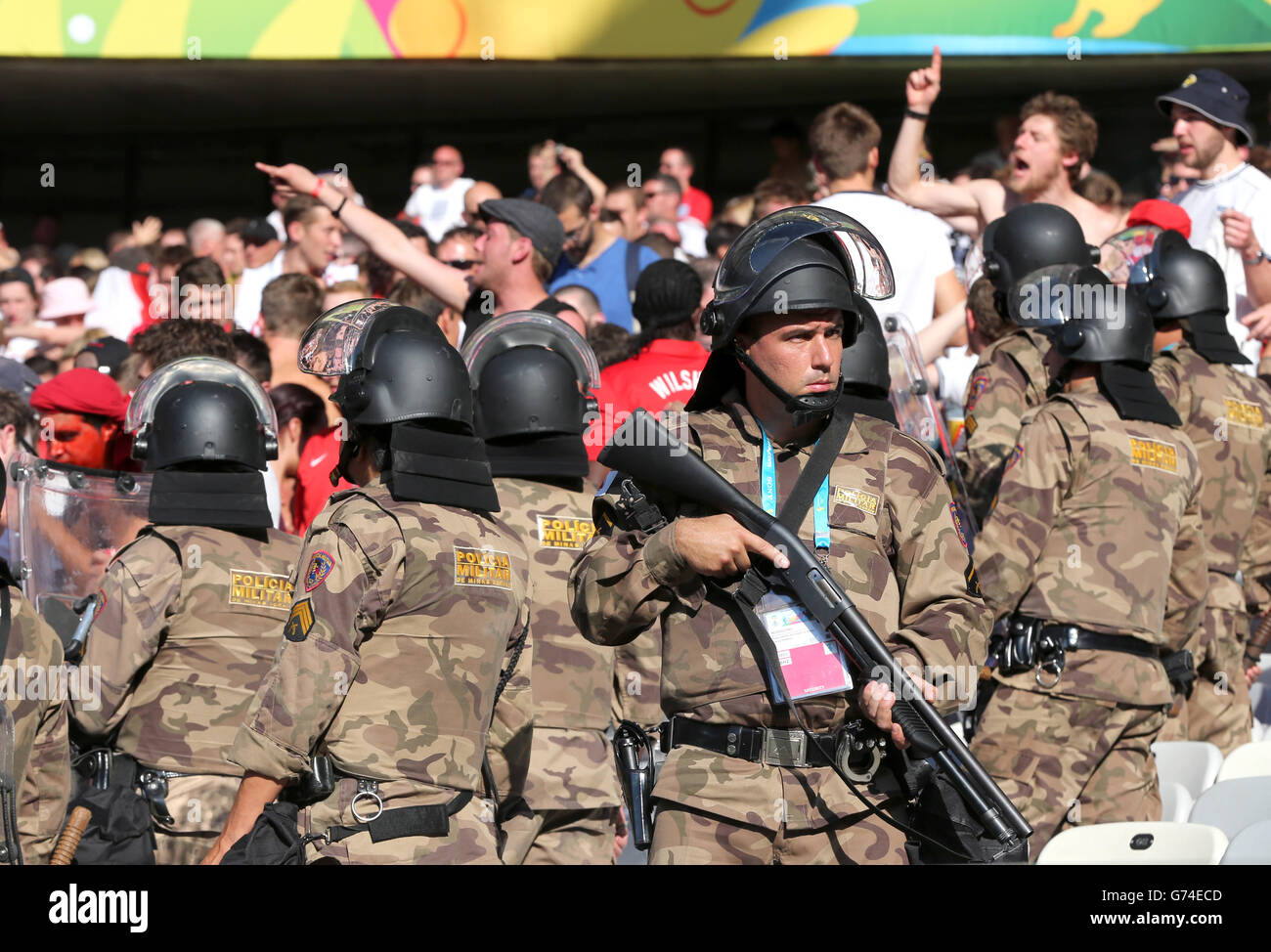 Military Police keep a watchful eye over England fans in the stands after the final whistle during the FIFA World Cup, Group D match at the Estadio Mineirao, Belo Horizonte, Brazil. Stock Photo