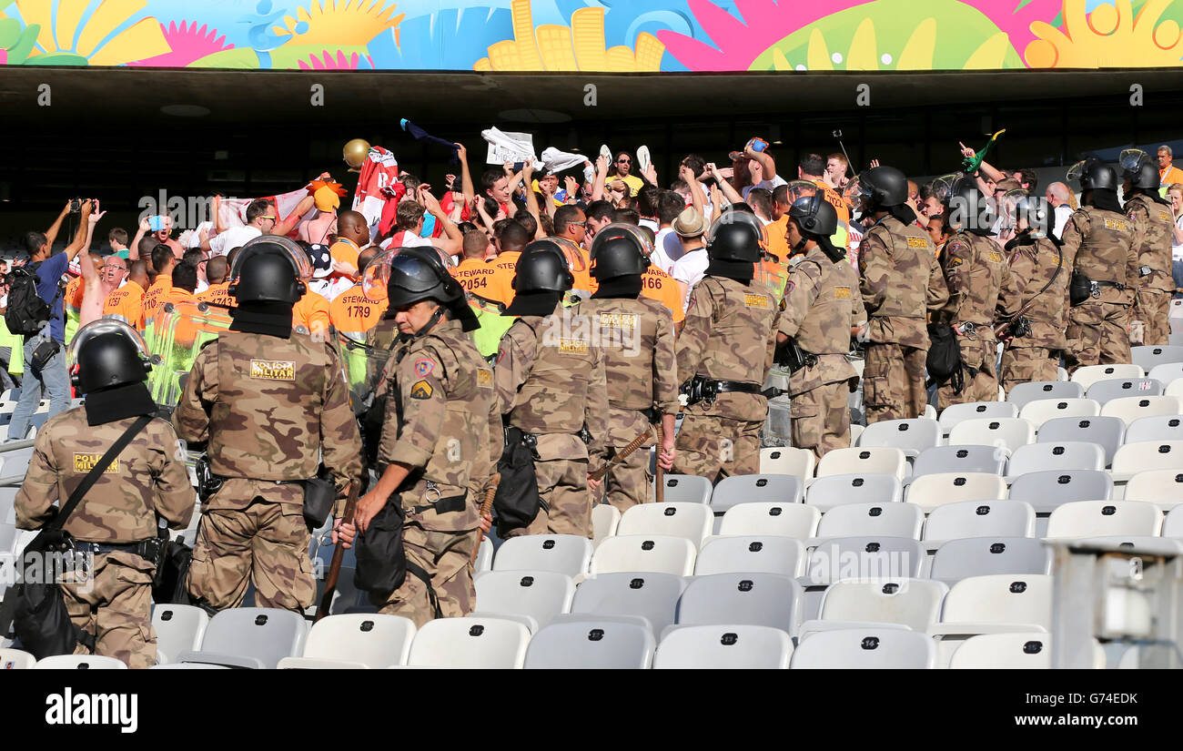 Military Police keep a watchful eye over England fans after the final whistle during the FIFA World Cup, Group D match at the Estadio Mineirao, Belo Horizonte, Brazil. Stock Photo