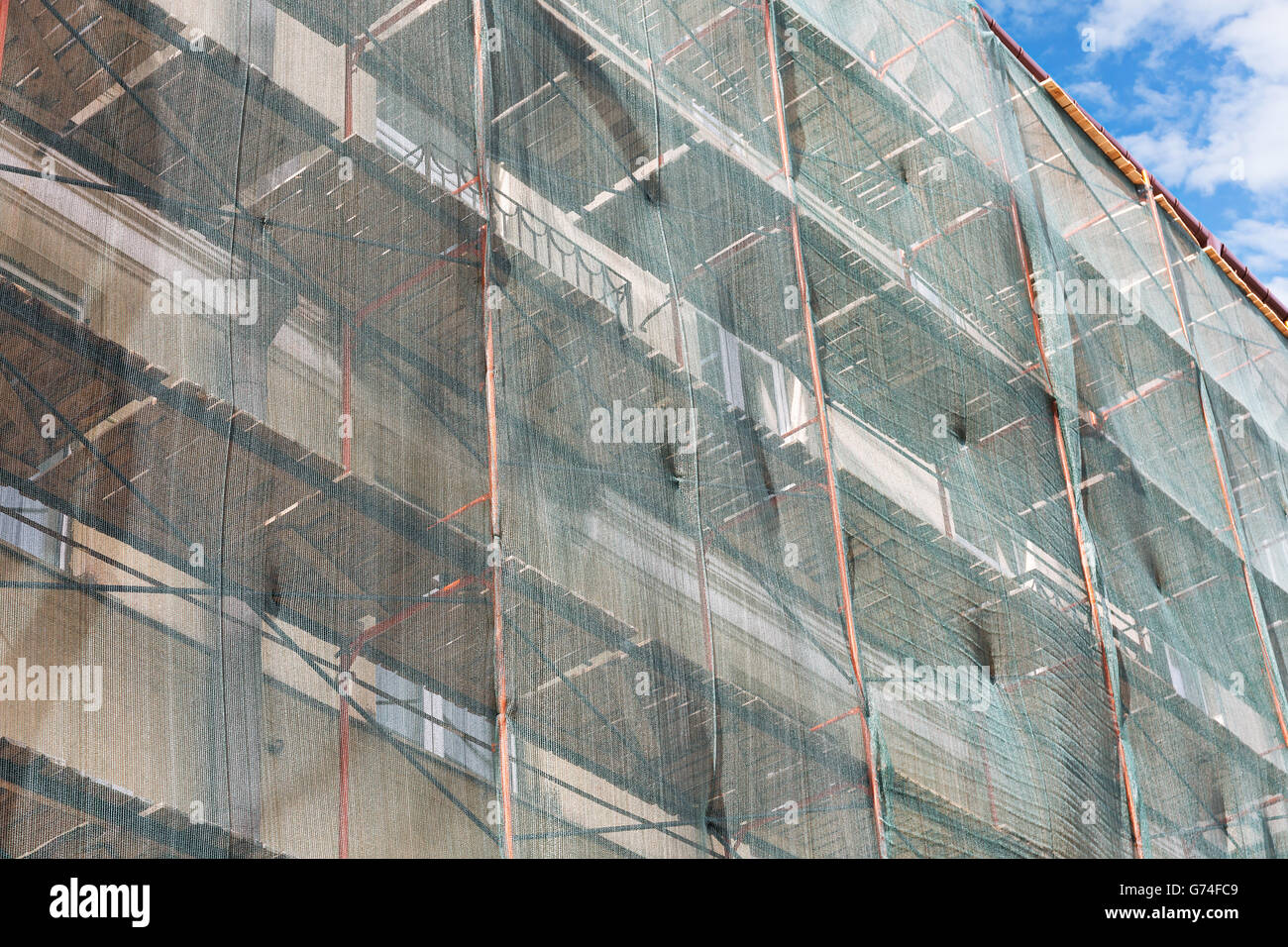 renovation apartment building exterior with scaffolding and green ... - Concrete Apartment Building Exterior Renovation