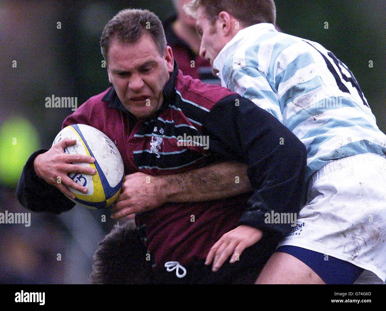 Cambridge University's Stuart Moffat (right) tackles Steele-Bodger's Greg Botterman during the 54th annual game between Cambridge University and Steele-Bodger at Grange Rd , Cambridge. * The Steele-Bodger side consists of professional Rugby Union players and competes with the Cambridge University team on an annual basis. Stock Photo