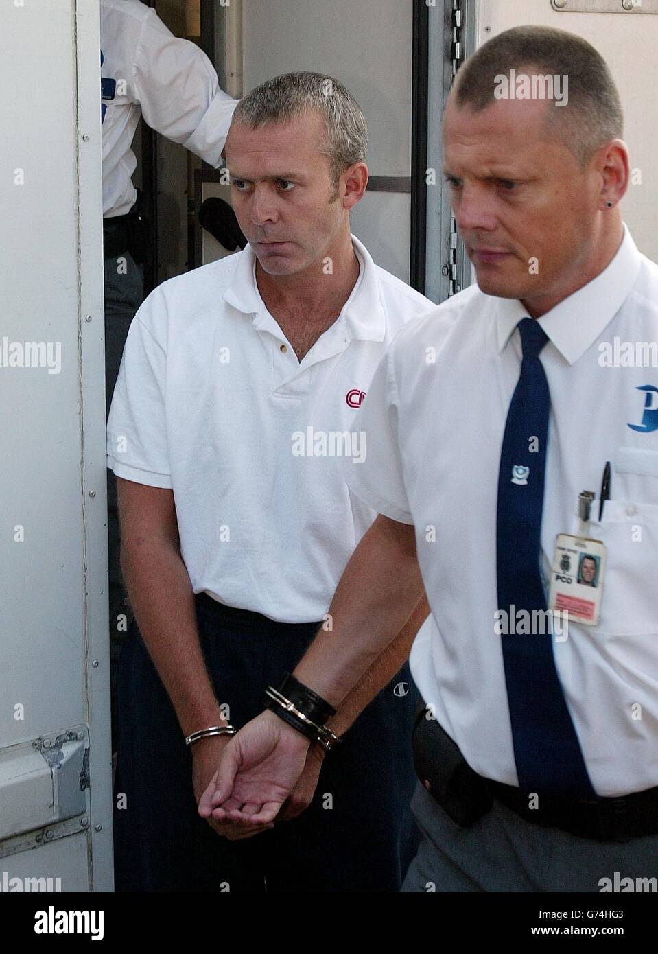 Andrew Wragg (left) arrives in handcuffs at Chichester Magistrate's ...