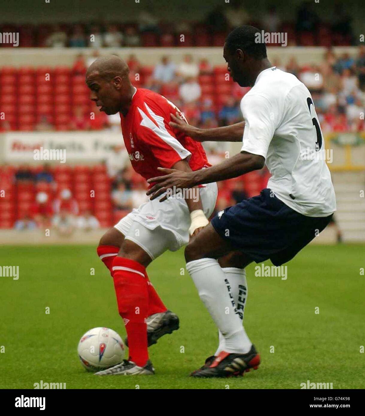 Nottingham Forest's Marlon King (left) holds off Tottenham Hotspur defender Ledley King. during their pre-season friendly match at the City Ground, Nottingham, Saturday July 31, 2004. Stock Photo