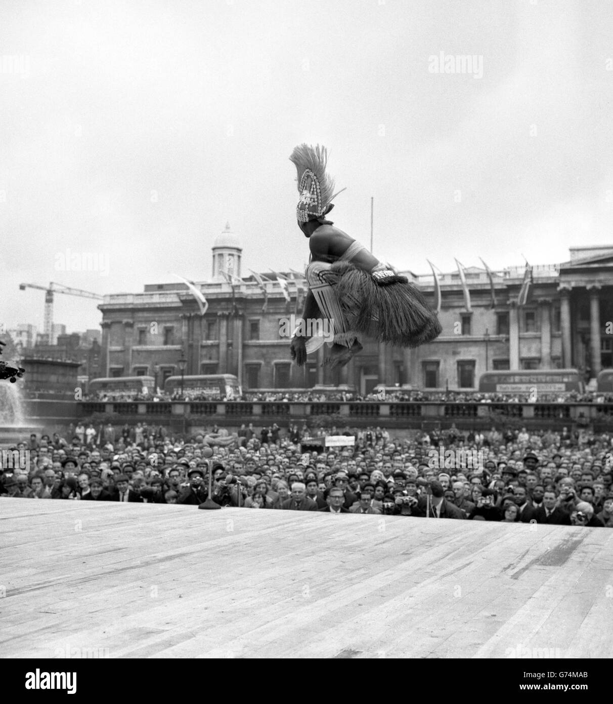 A dancer from the Sierra Leone National Dance Troupe performs in Trafalgar Square, London, as part of the Commonwealth Arts Festival. Stock Photo