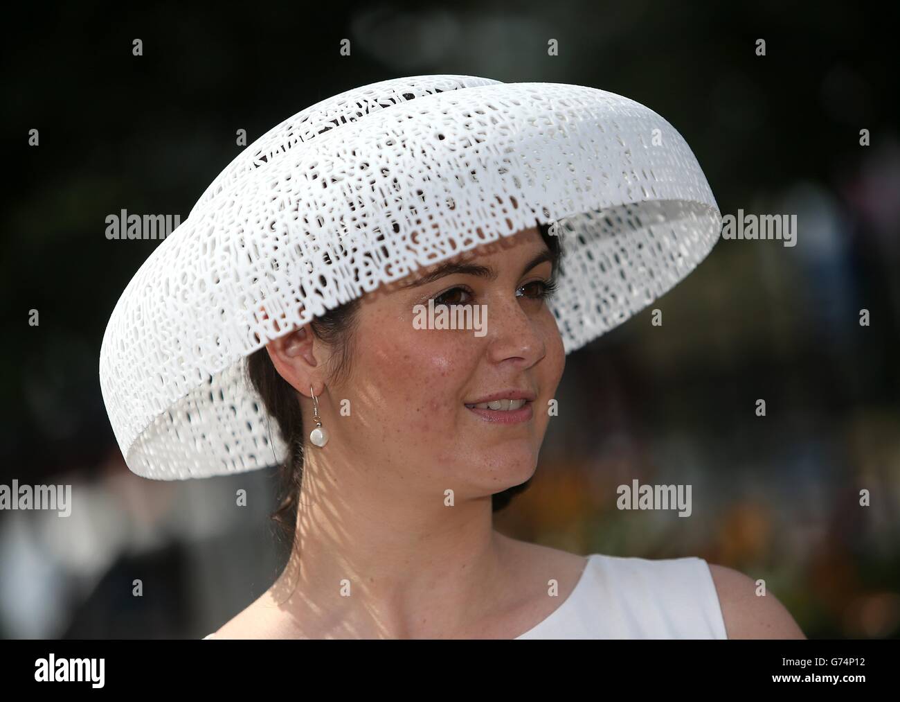 Racegoer Stephanie Emsten, 25, from Newmarket poses for photographers wearing a 3D printed hat of the Ascot Poem during Day Three of the 2014 Royal Ascot Meeting at Ascot Racecourse, Berkshire. Stock Photo