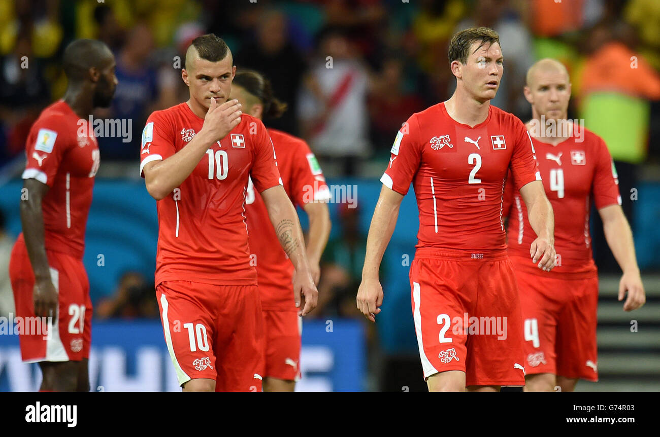 Soccer - FIFA World Cup 2014 - Group E - Switzerland v France - Arena Fonte Nova. Switzerland's Stephan Lichtsteiner (2) and Switzerland's Granit Xhaka (10) look dejected after the final whistle Stock Photo