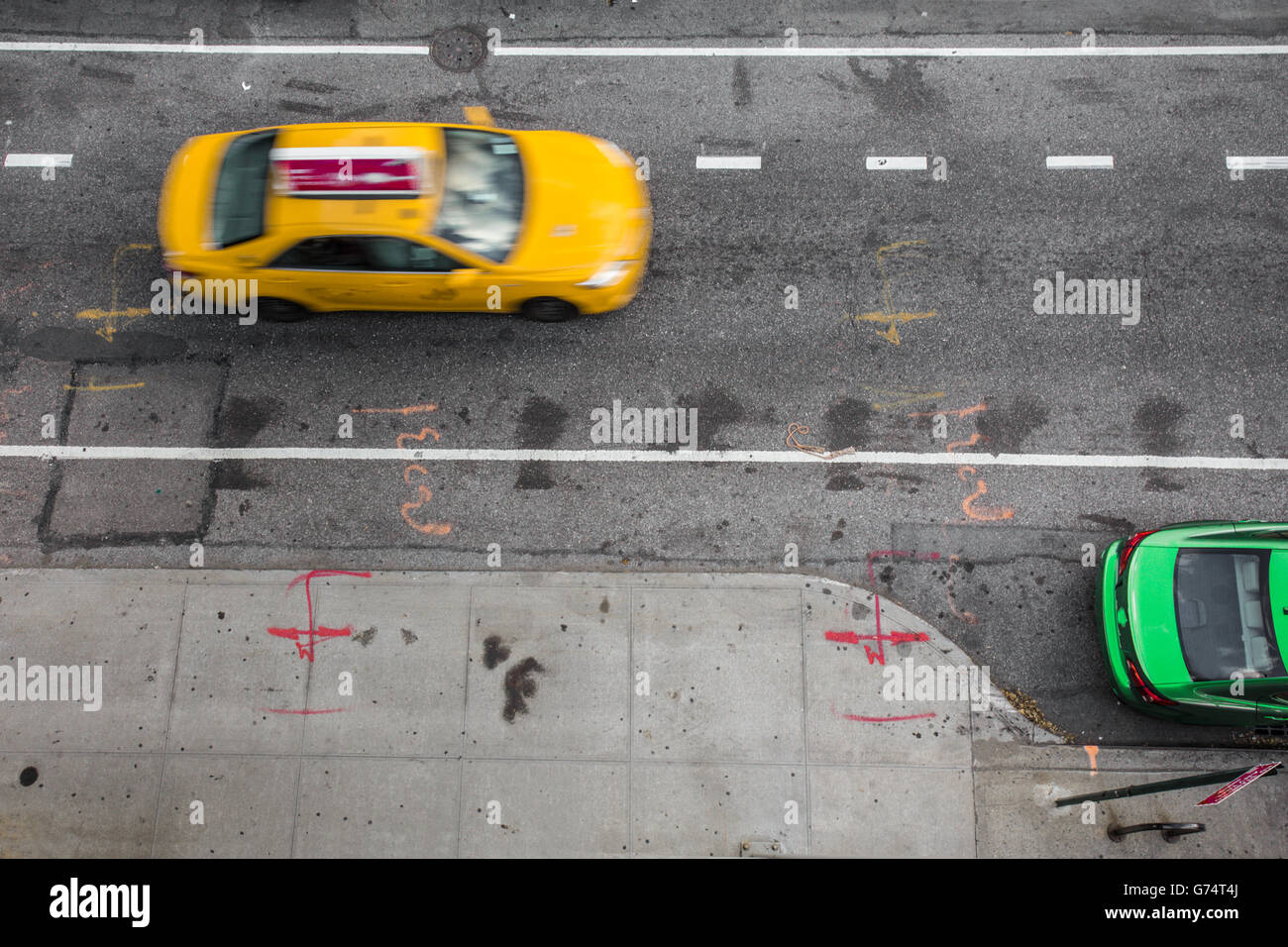 Overhead view of New York City street scene with Yellow taxi cab and green car Stock Photo