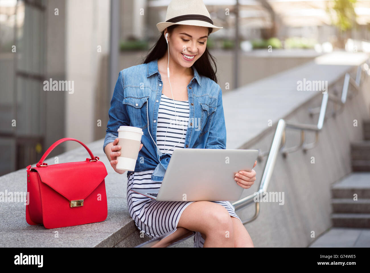 Cheerful woman using laptop Stock Photo - Alamy