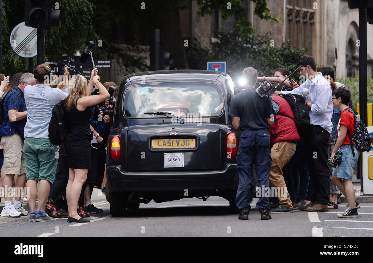 Members of the media surround the taxi carrying former News of the World editor Andy Coulson as he leaves the Old Bailey in London, after Prime Minister David Cameron was heavily criticised for almost collapsing the phone hacking trial in its final stages by commenting on ex No 10 spin doctor Andy Coulson's conviction for phone hacking while the jury was still deliberating. Stock Photo