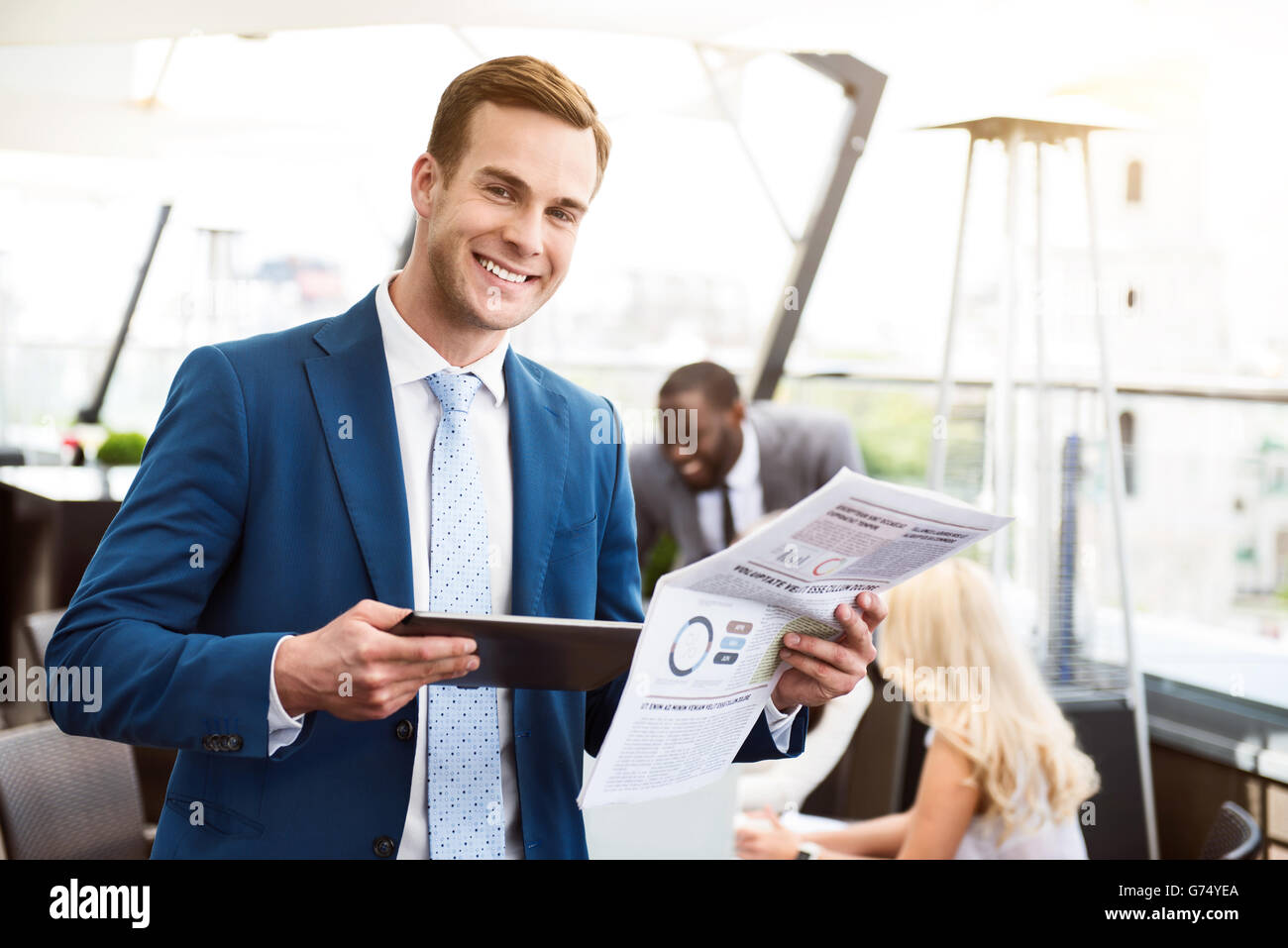 Handsome smiling man standing in the office Stock Photo - Alamy